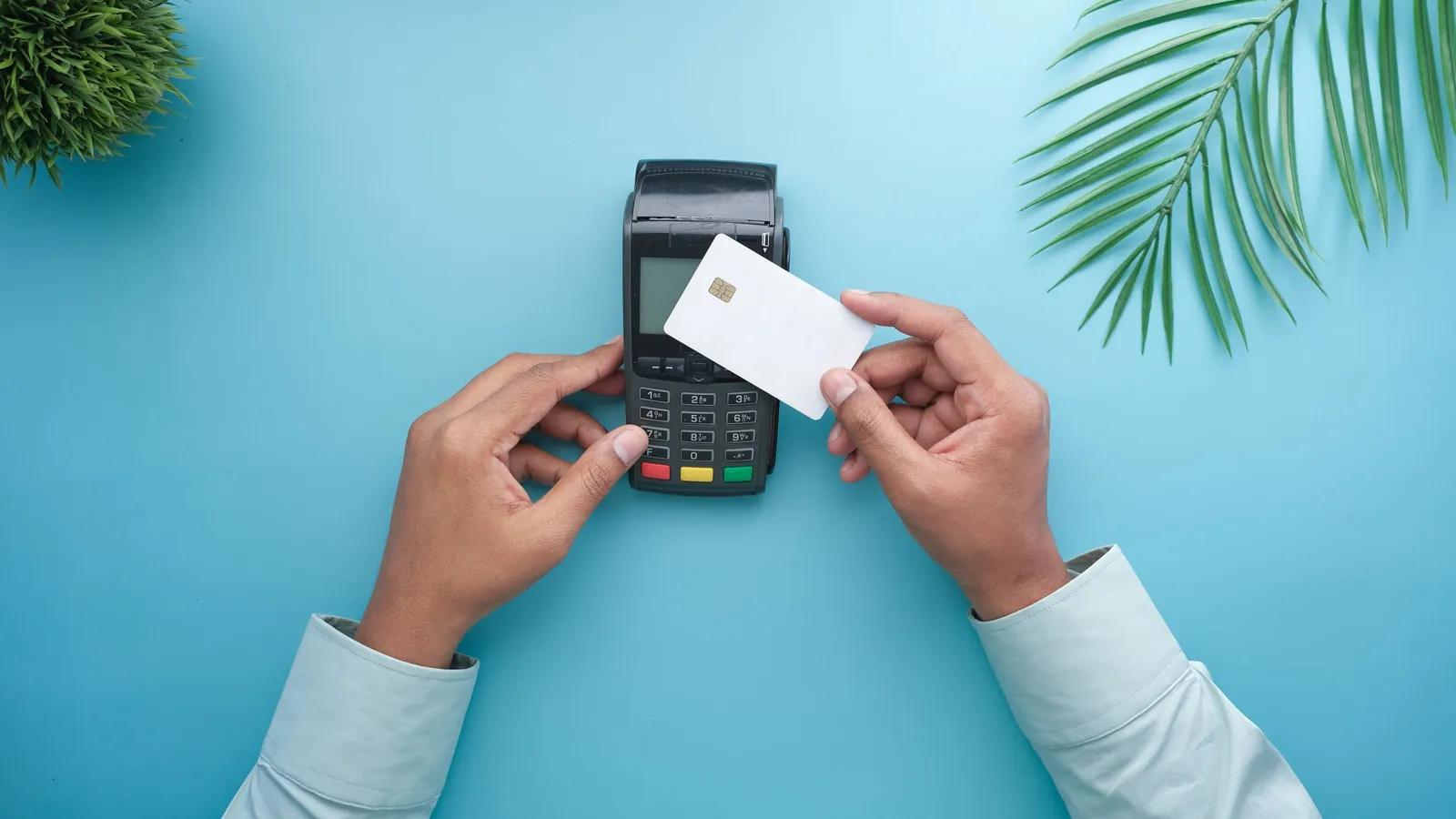 A hand making a contactless card payment on a small terminal, standing in for AI agents that can now complete a purchase from start to finish, not just recommend a store.